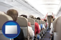 colorado map icon and airline passengers in a commercial jetliner