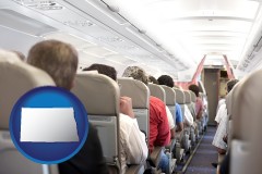 north-dakota map icon and airline passengers in a commercial jetliner